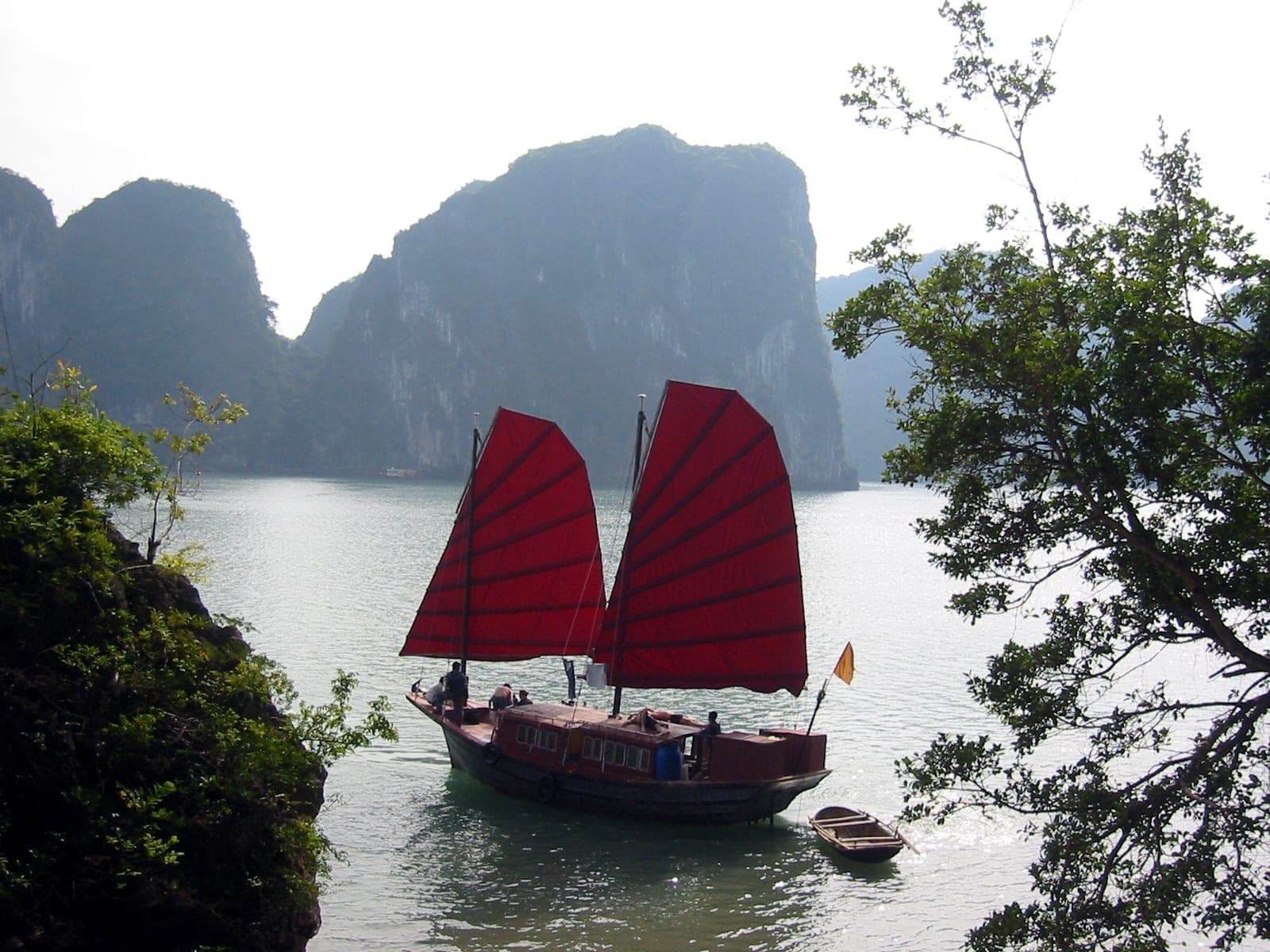 A traditional red-sailed junk boat in Ha Long Bay
