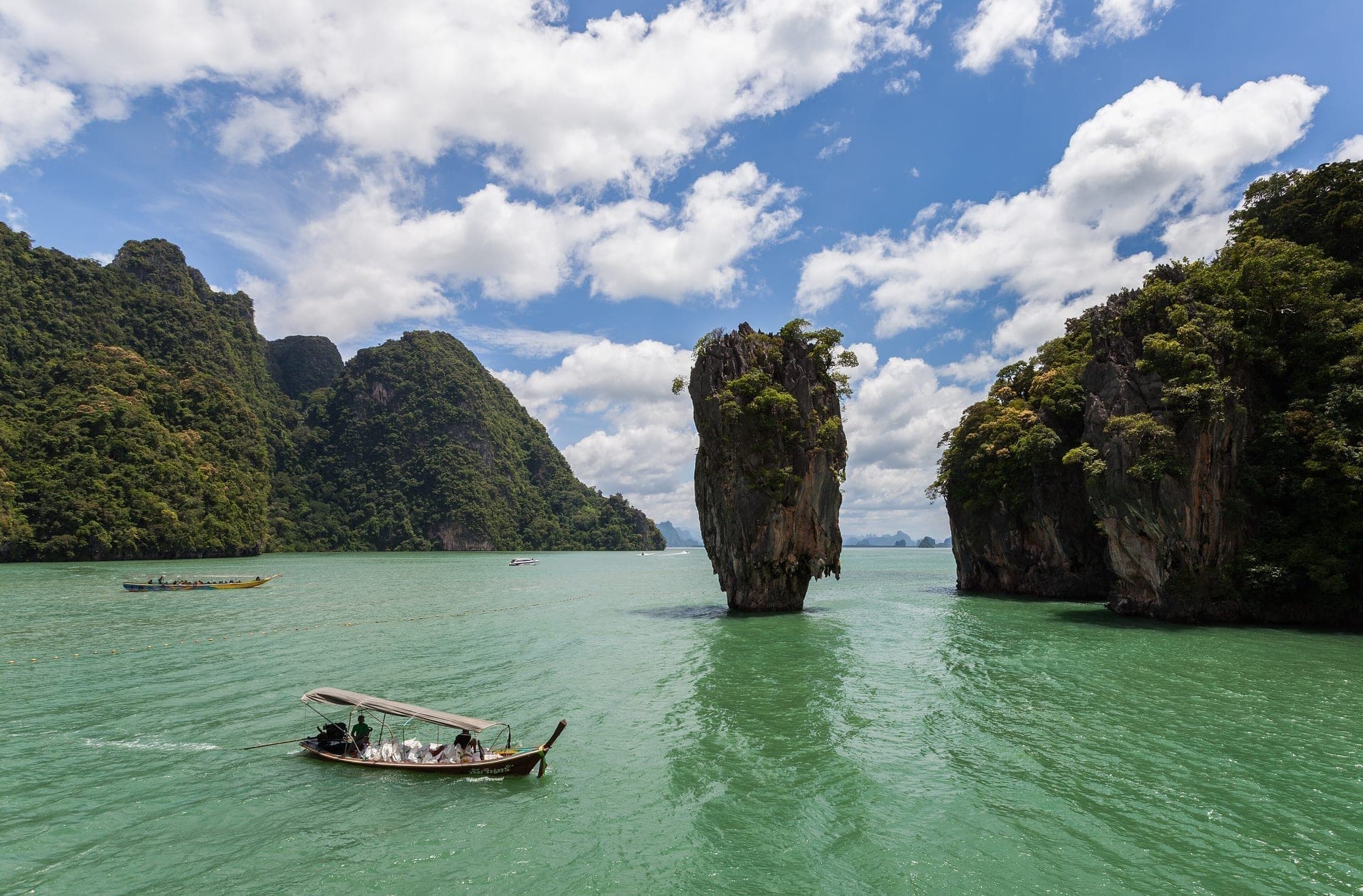 Limestone islands and a longtail boat in Phang Nga Bay, Thailand