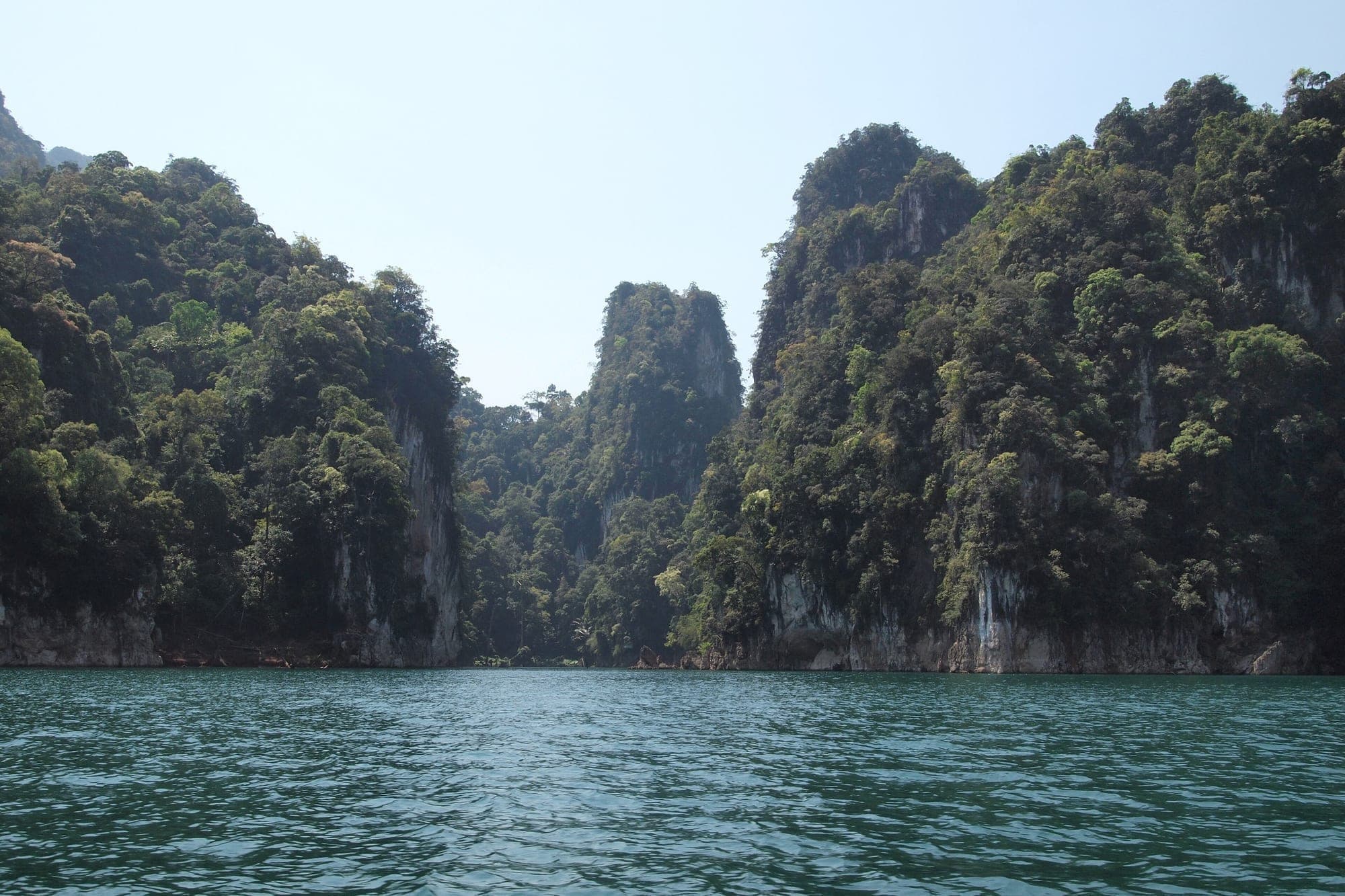 Limestone cliffs rising from the emerald water of Cheow Lan Lake