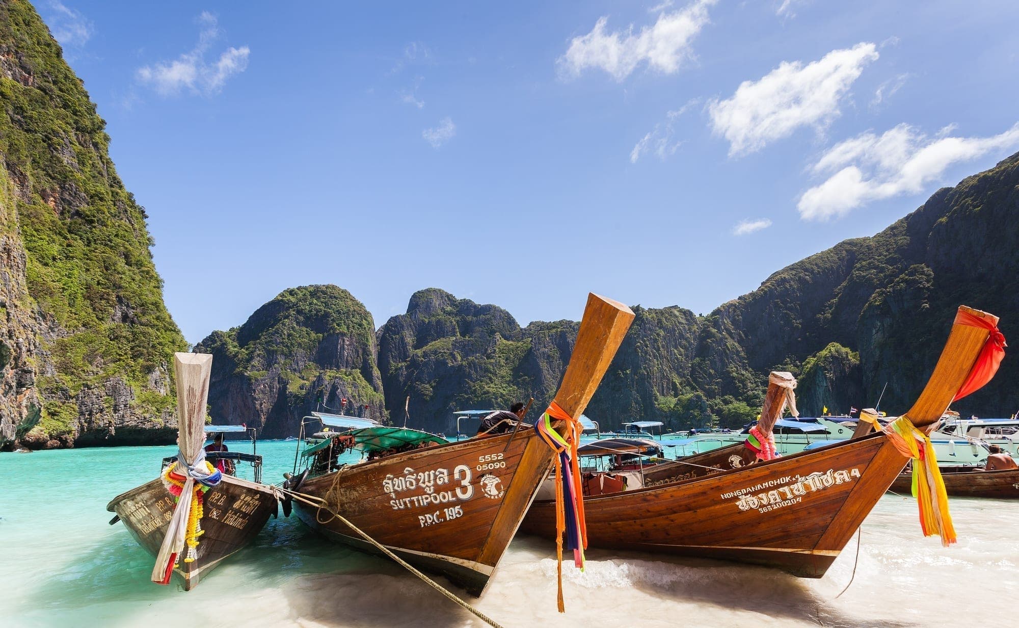 Longtail boats moored in a bay in the Phi Phi Islands, Thailand
