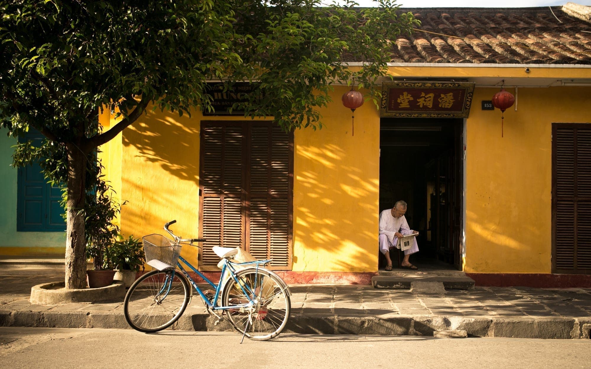 A bicycle against a yellow wall in the old town of Hoi An